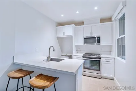 a kitchen with a stove a sink and a refrigerator