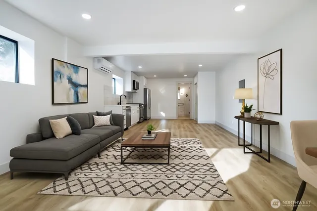 a living room with furniture and a wooden floor