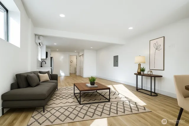 a living room with furniture and wooden floor