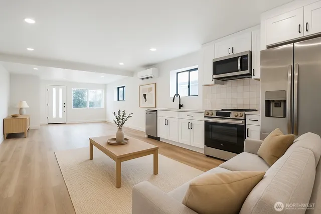 a living room with a couch and a view of kitchen