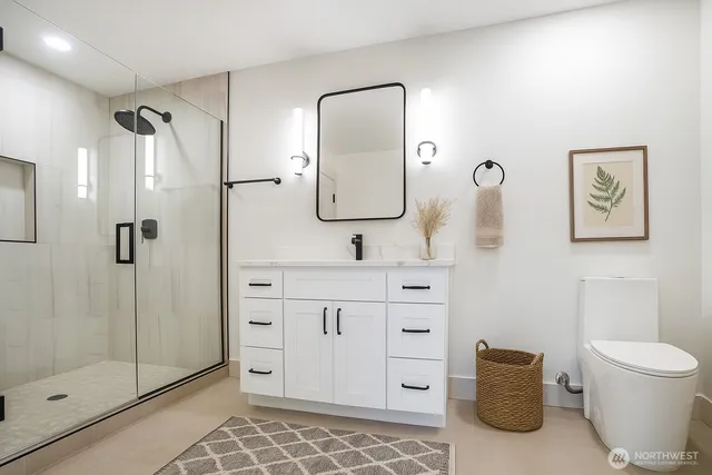 a bathroom with a toilet sink and shower