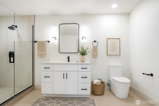 a bathroom with a toilet a sink and mirror