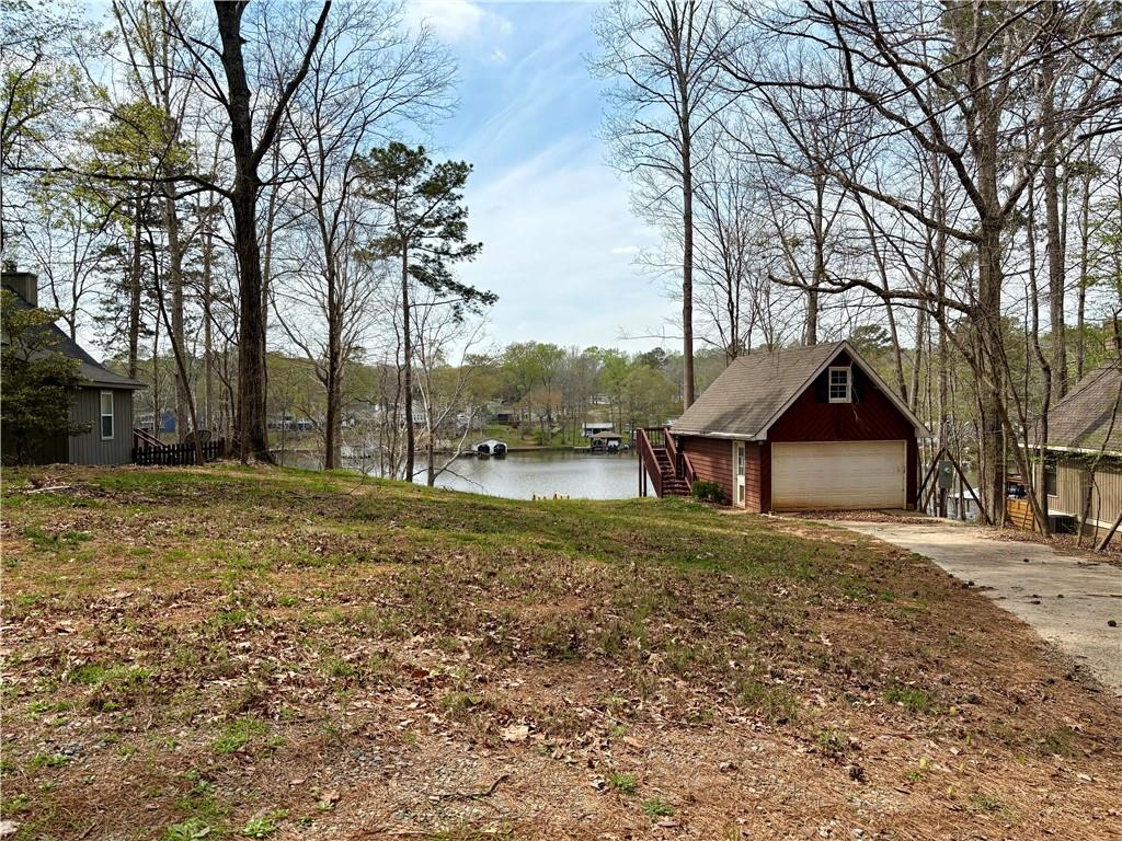 139 Bear Creek Road Eatonton, GA 31024 - Photo 1 of 8 a front view of house with yard and trees