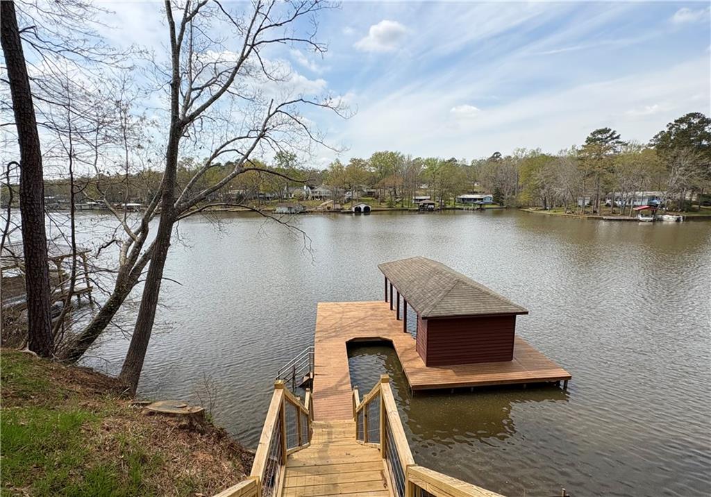 139 Bear Creek Road Eatonton, GA 31024 - Photo 2 of 8 a view of a lake with a bench and trees