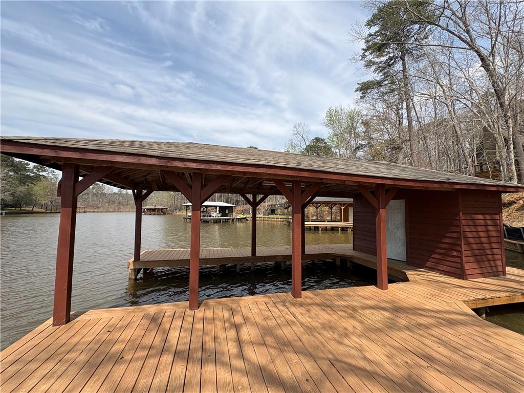 139 Bear Creek Road Eatonton, GA 31024 - Photo 6 of 8 a view of a balcony with two chairs and a potted plant