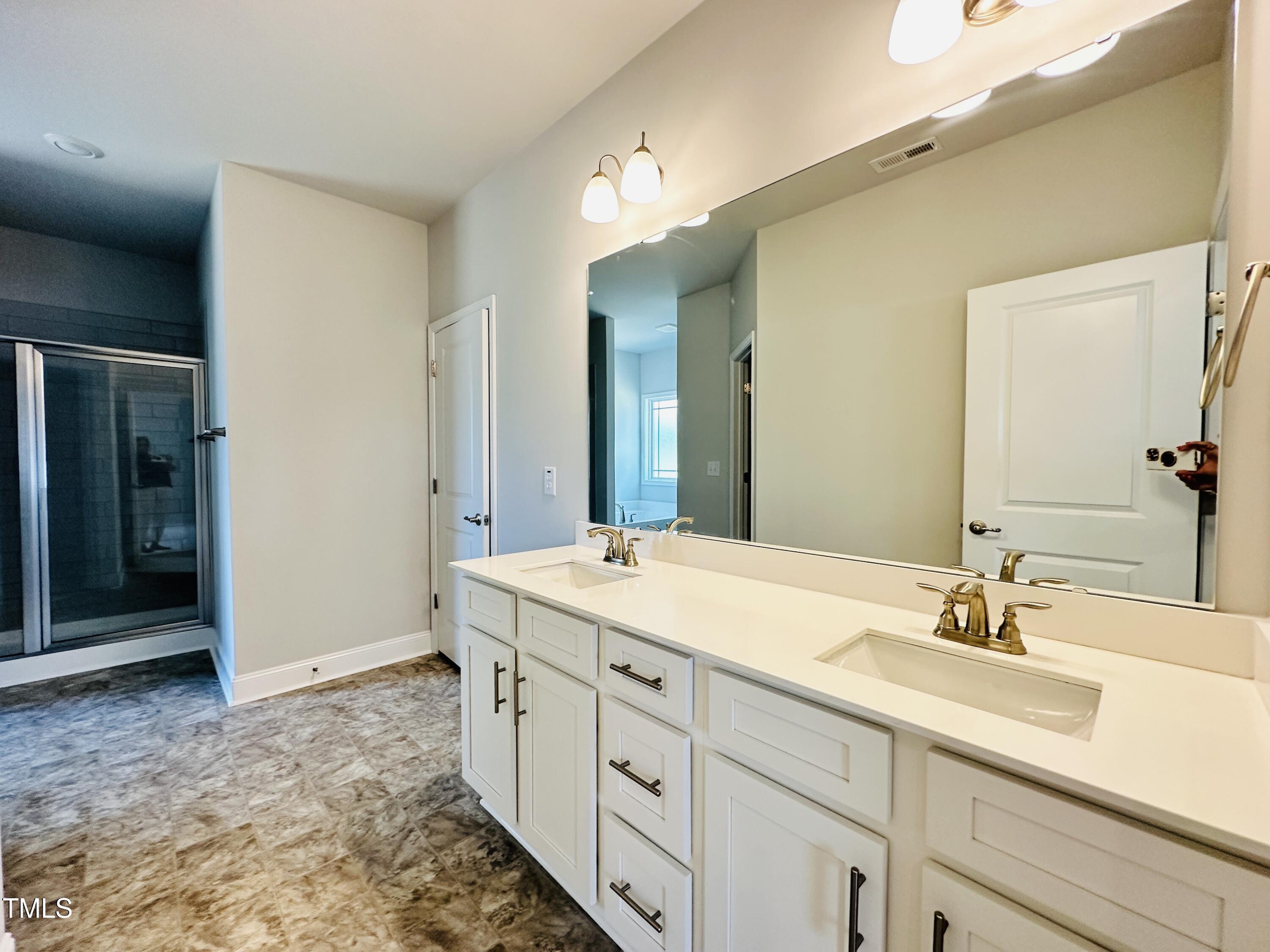 4020 Fletcher Road Bailey, NC 27807 - Photo 17 of 30 a spacious bathroom with a sink and a mirror