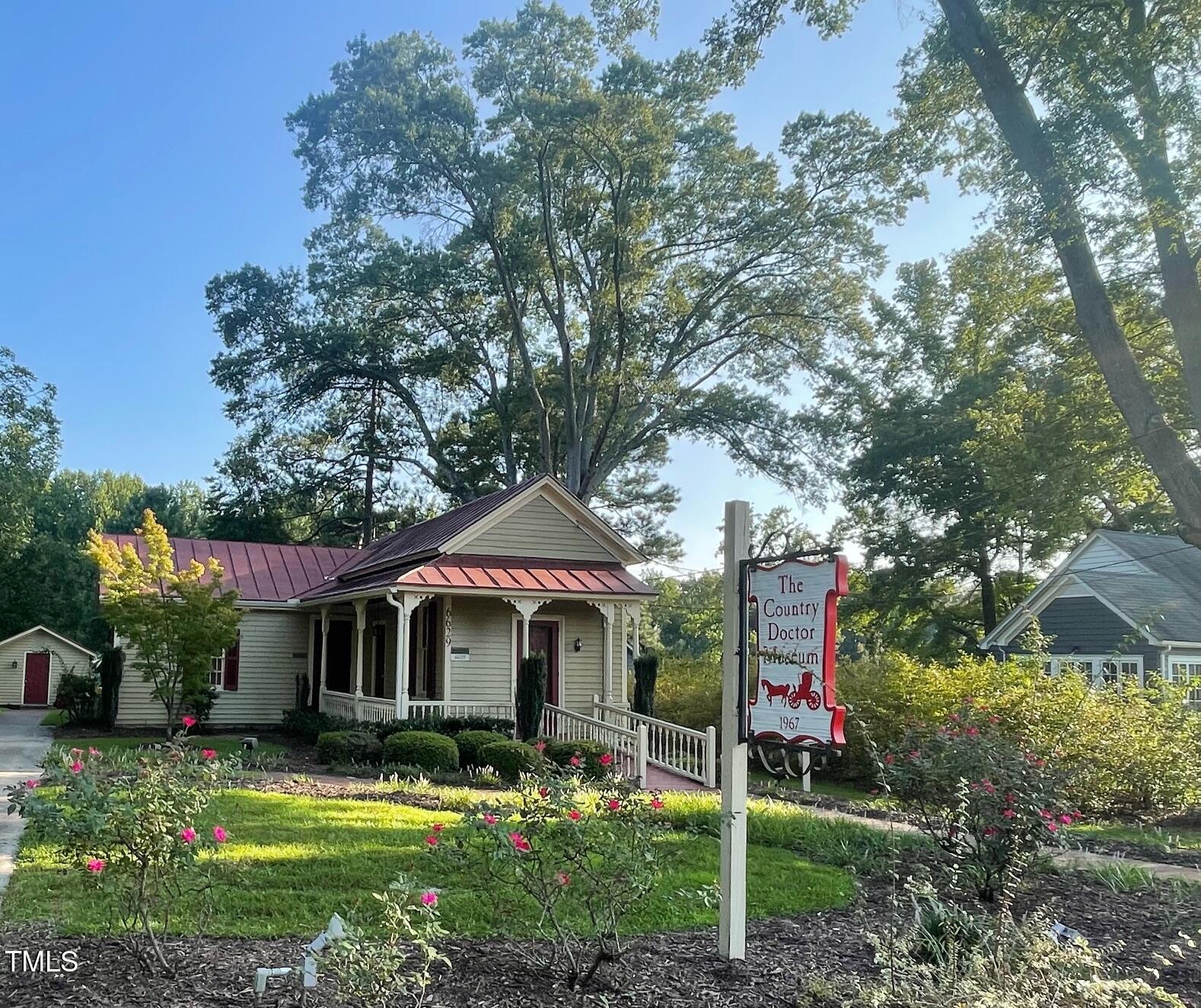 4020 Fletcher Road Bailey, NC 27807 - Photo 28 of 30 a front view of a house with a garden and tree