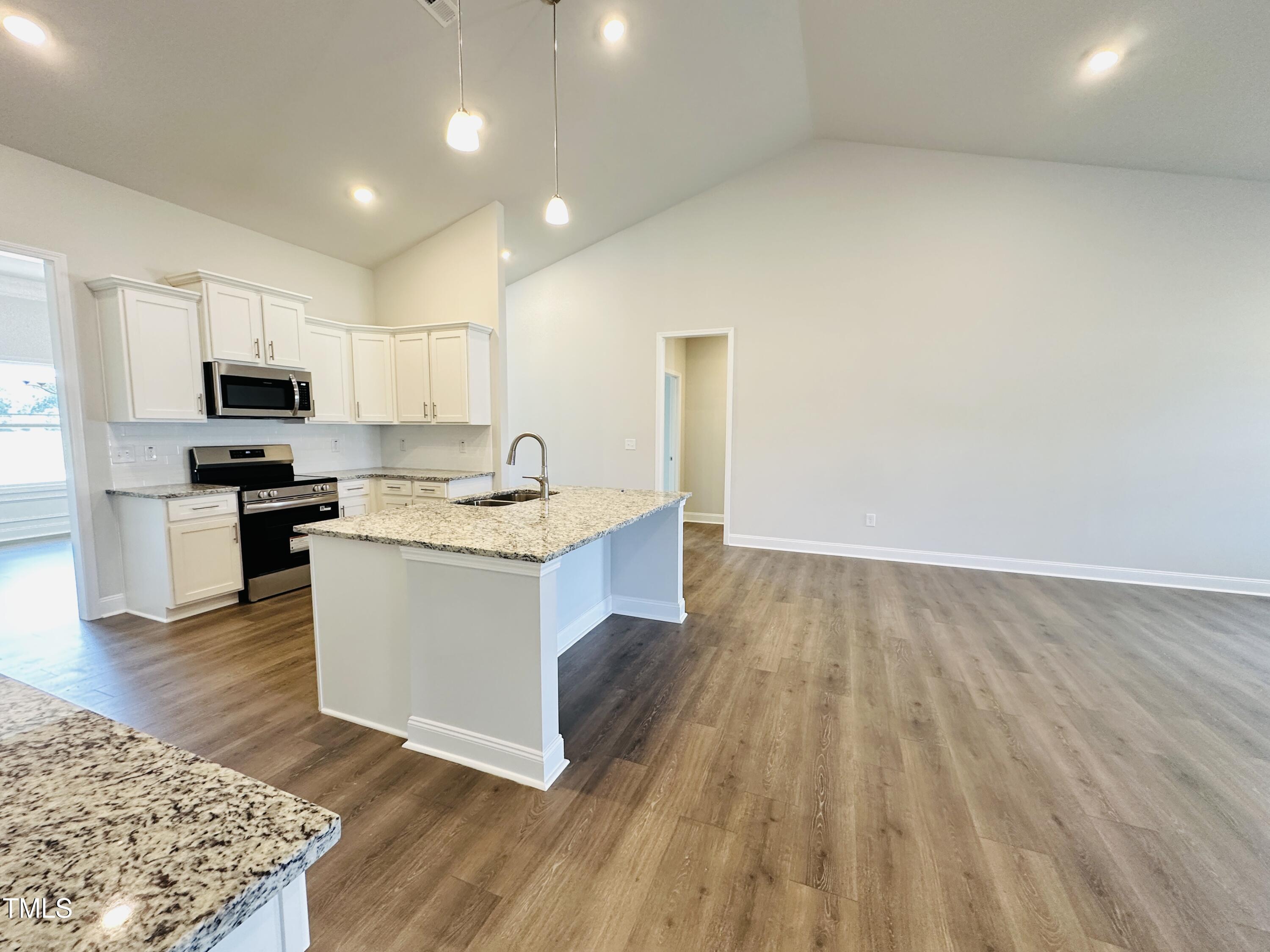 4020 Fletcher Road Bailey, NC 27807 - Photo 7 of 30 a kitchen with wooden floors and white appliances