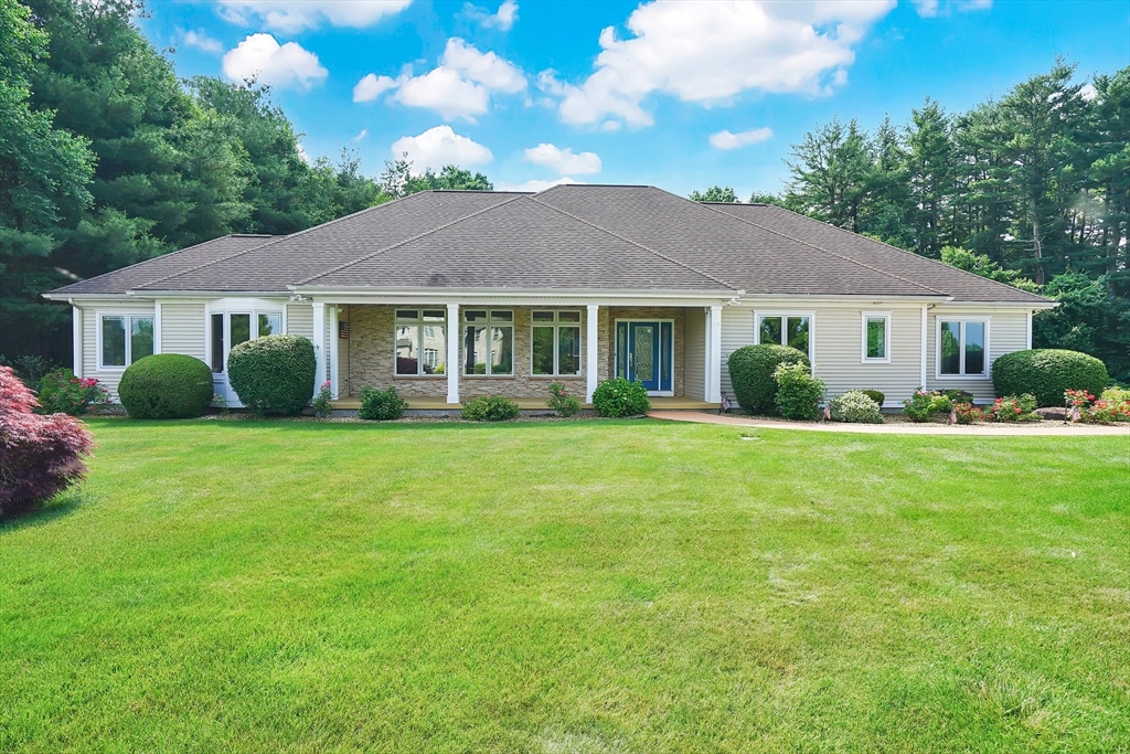 a front view of a house with a garden