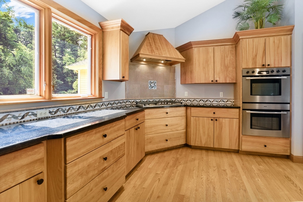 89 Nottingham Drive East Longmeadow, MA 01028 - Photo 12 of 40 a kitchen with granite countertop a sink cabinets stainless steel appliances and a large window