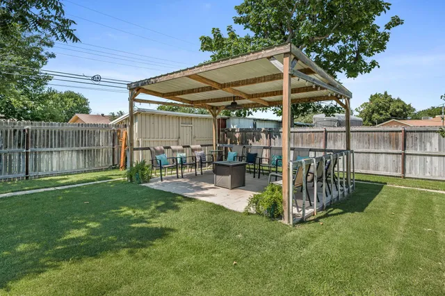 a view of a chair and table in backyard