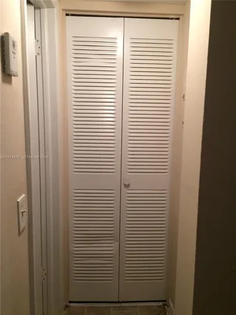 a bathroom with a glass door shower and a sink