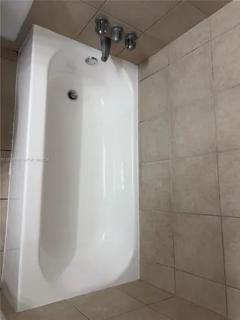 a bathroom with a toilet and a shower curtain