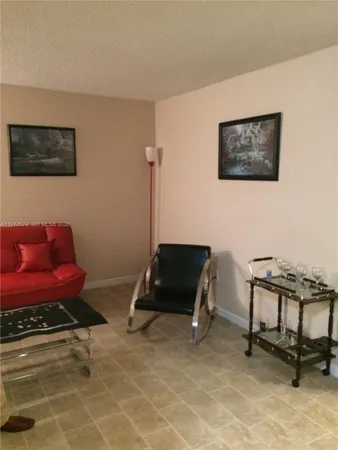 a living room with furniture a rug and a table