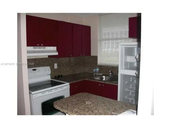 a kitchen with a sink cabinets and appliances