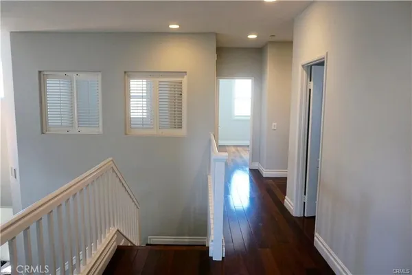 a view of hallway with wooden floor