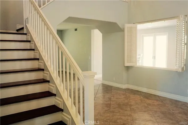 a view of staircase with wooden floor and a window