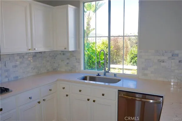 a kitchen with a sink and large window