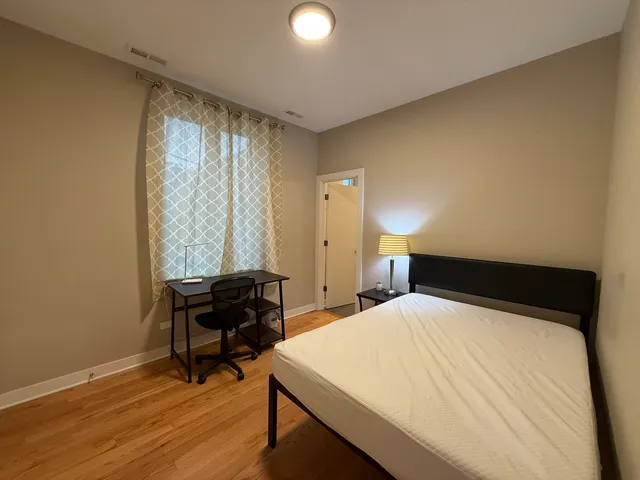 a bedroom with a bed and a desk