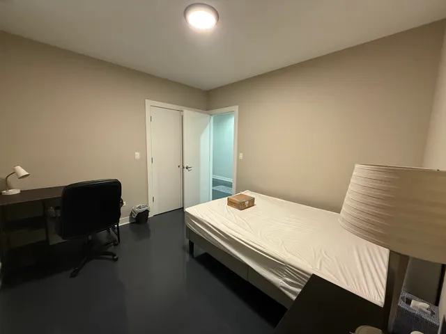 a bedroom with a bed and chair