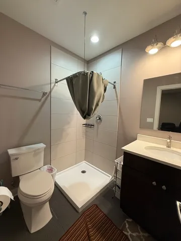 a bathroom with a toilet sink and shower
