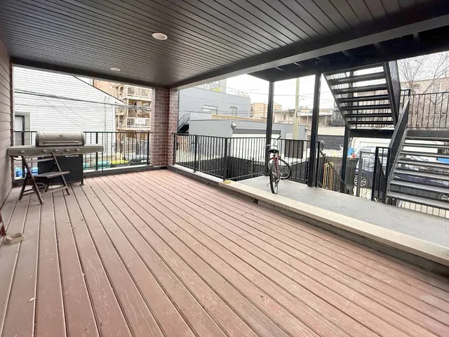 a view of balcony with wooden floor
