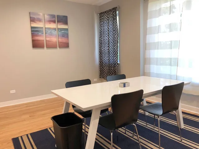 a view of a dining room with furniture and window