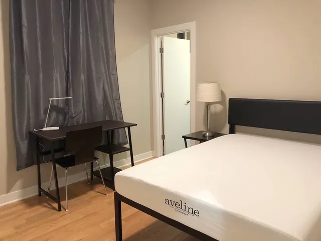 a bedroom with a bed and a table