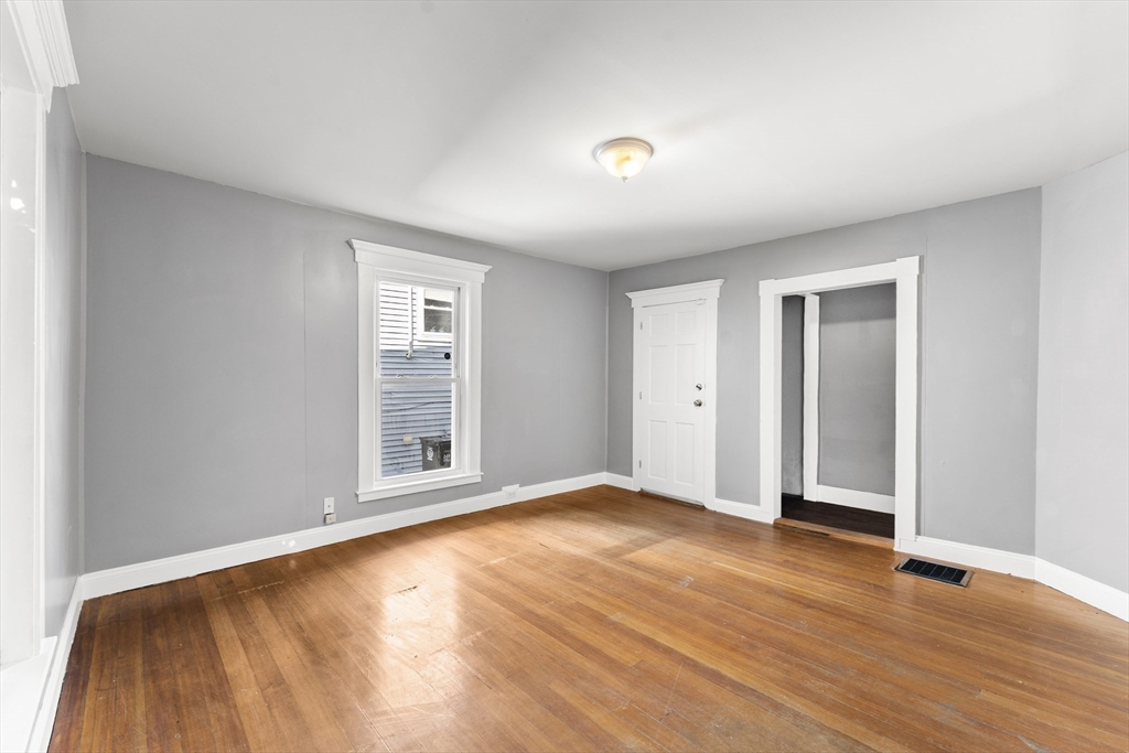 211 Burrill Street Swampscott, MA 01907 - Photo 12 of 39 a view of an empty room with wooden floor and window