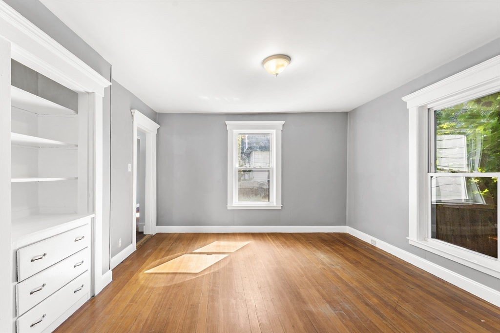 211 Burrill Street Swampscott, MA 01907 - Photo 13 of 39 a view of an empty room with wooden floor and a window