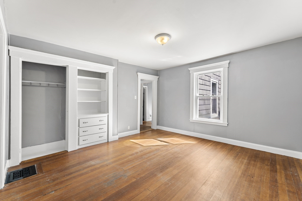 211 Burrill Street Swampscott, MA 01907 - Photo 15 of 39 an empty room with windows and closet