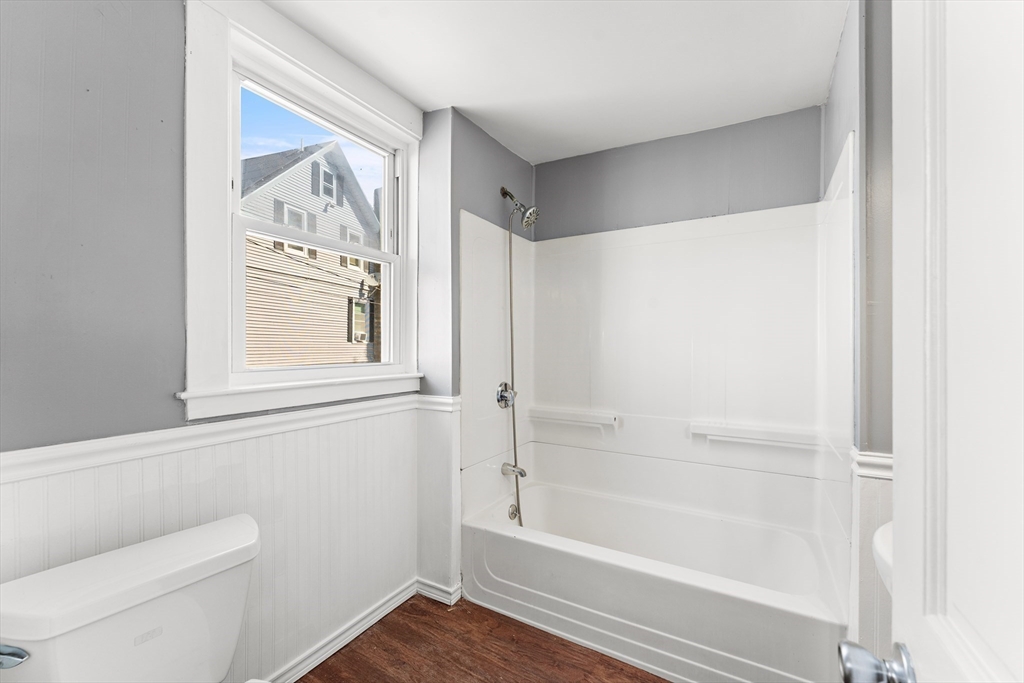 211 Burrill Street Swampscott, MA 01907 - Photo 16 of 39 a bathroom with a toilet and a bathtub