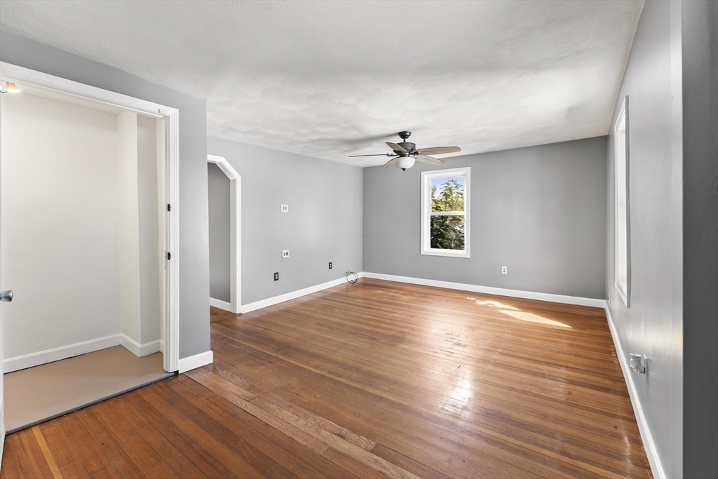 211 Burrill Street Swampscott, MA 01907 - Photo 20 of 39 a view of empty room with wooden floor and fan