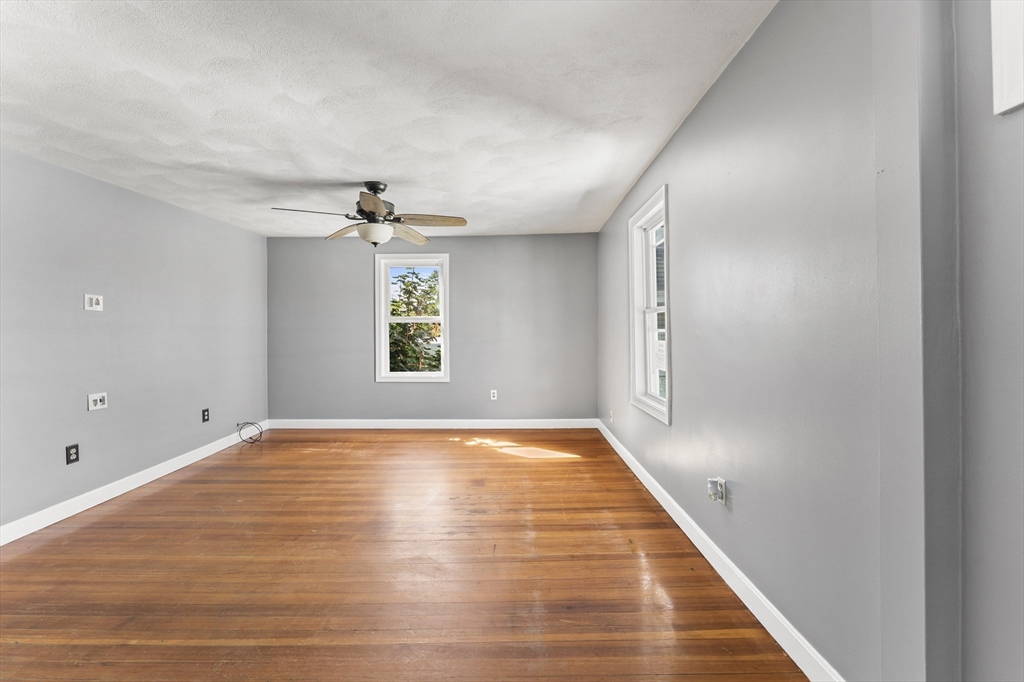 211 Burrill Street Swampscott, MA 01907 - Photo 21 of 39 wooden floor in an empty room with a window