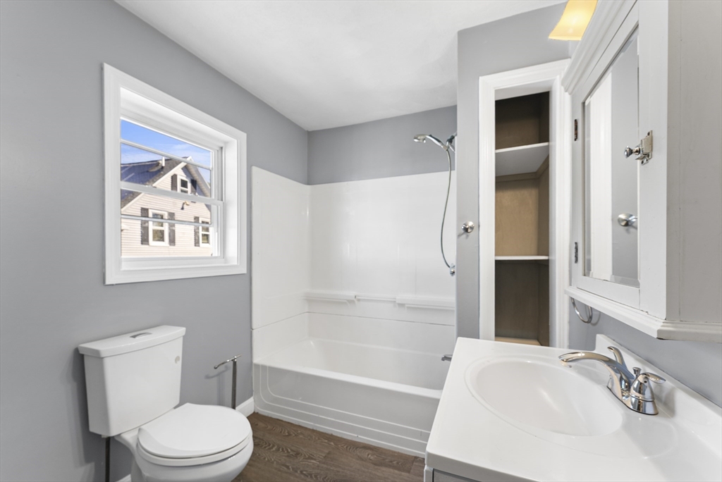 211 Burrill Street Swampscott, MA 01907 - Photo 29 of 39 a bathroom with a granite countertop toilet a sink and bathtub