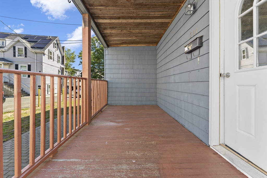 211 Burrill Street Swampscott, MA 01907 - Photo 34 of 39 a view of a porch with wooden floor and stairs