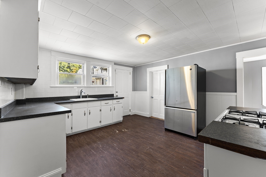 211 Burrill Street Swampscott, MA 01907 - Photo 6 of 39 a kitchen with a refrigerator and a sink