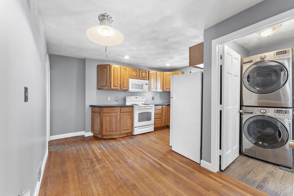 211 Burrill Street Swampscott, MA 01907 - Photo 8 of 39 a kitchen with a refrigerator and window