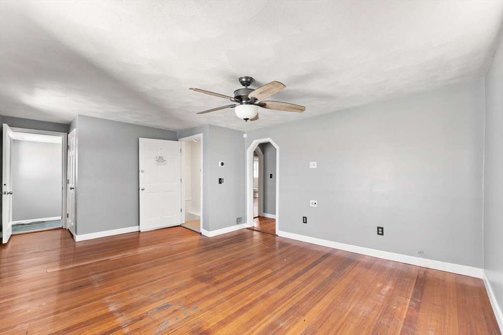 211 Burrill Street Swampscott, MA 01907 - Photo 10 of 39 wooden floor in an empty room with a window