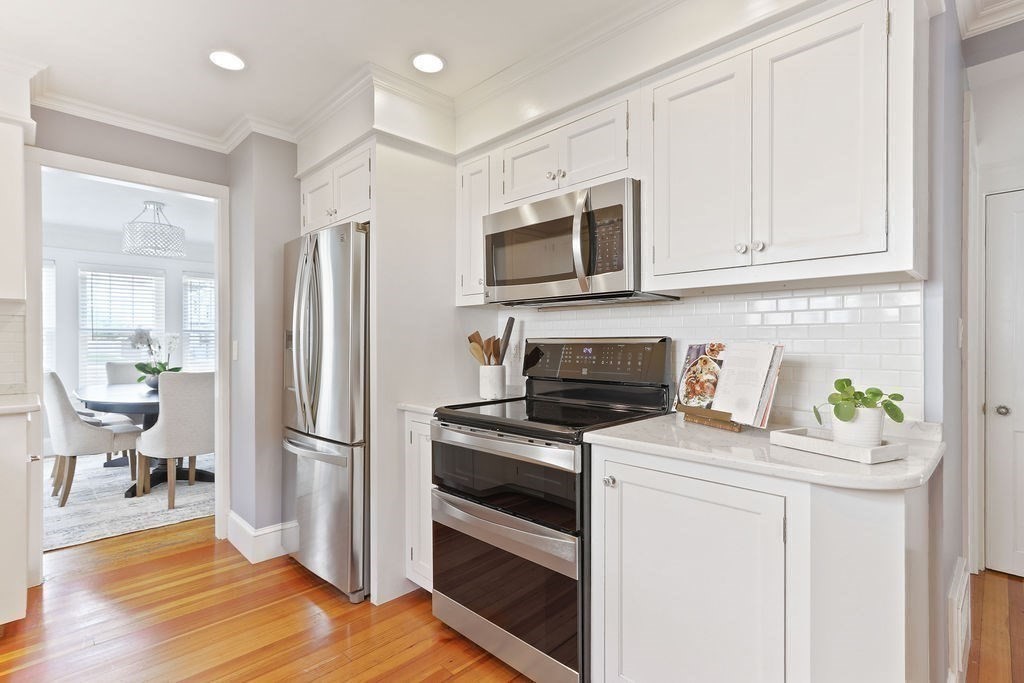 1097 Greendale Avenue Needham, MA 02492 - Photo 13 of 36 a kitchen with stainless steel appliances a stove microwave and a refrigerator