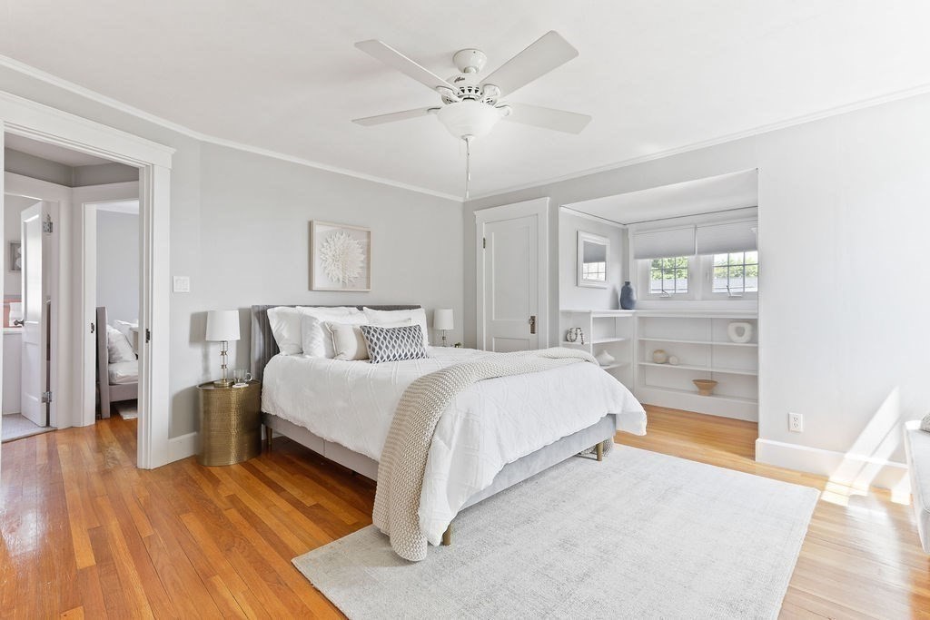 1097 Greendale Avenue Needham, MA 02492 - Photo 21 of 36 a spacious bedroom with a bed and a ceiling fan