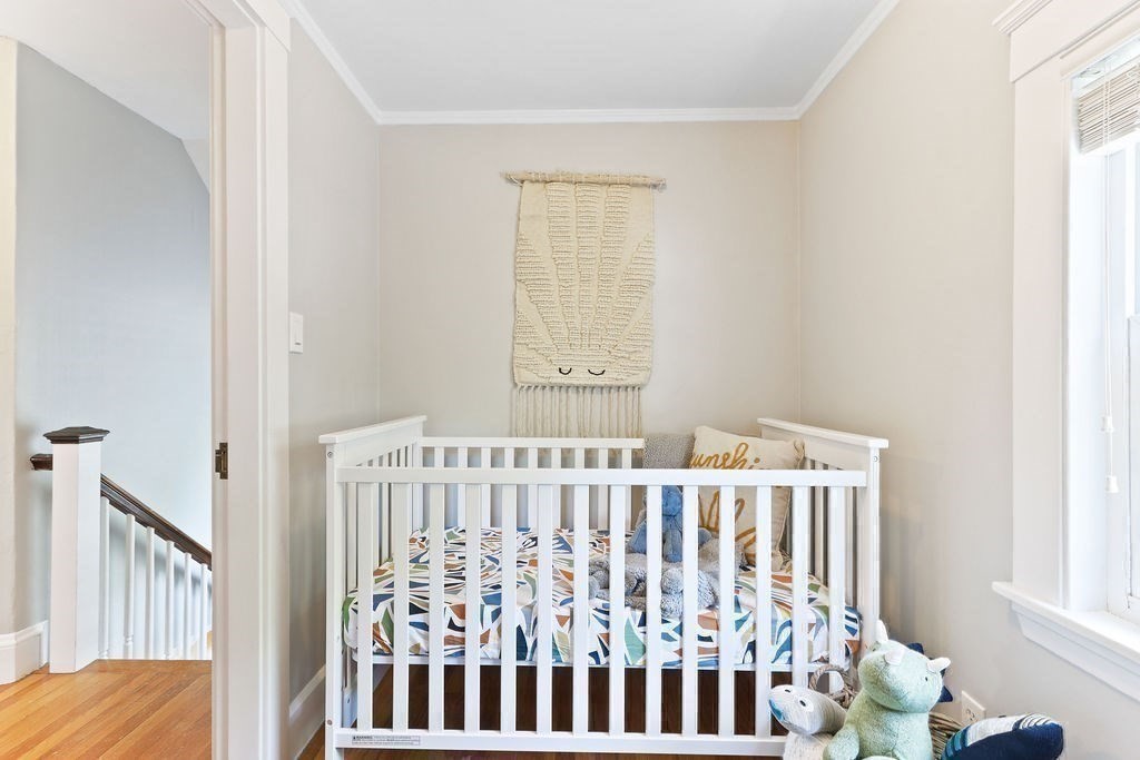 1097 Greendale Avenue Needham, MA 02492 - Photo 27 of 36 a bedroom with a window and wooden floor
