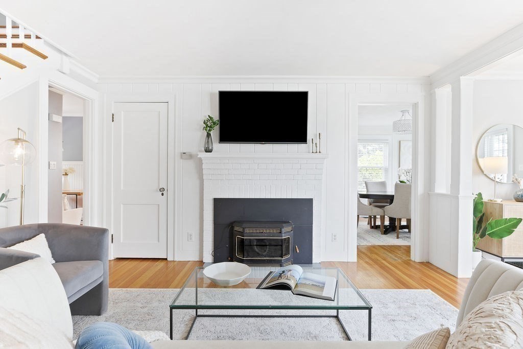 1097 Greendale Avenue Needham, MA 02492 - Photo 7 of 36 a living room with furniture a flat screen tv and a fireplace