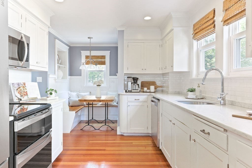 1097 Greendale Avenue Needham, MA 02492 - Photo 10 of 36 a kitchen with a sink stove and white cabinets