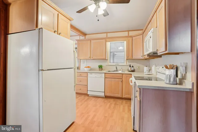 a kitchen with a refrigerator a sink and cabinets