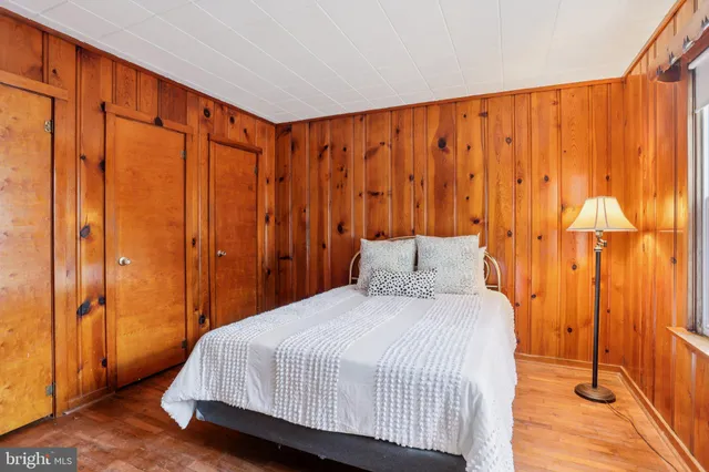 a bedroom with a bed and curtain