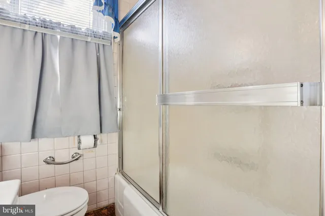 a bathroom with a shower and a toilet