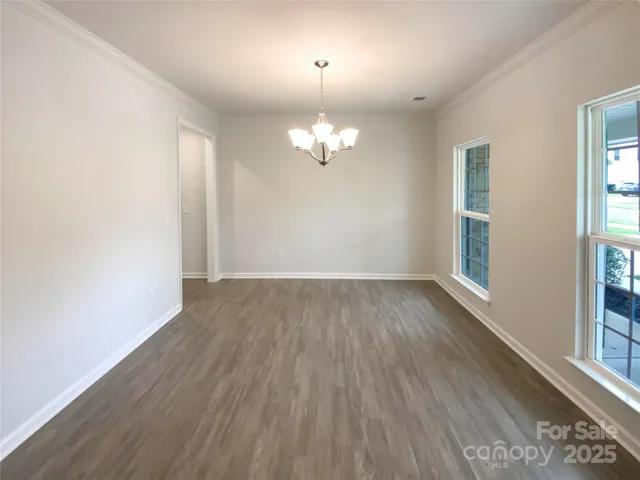 an empty room with wooden floor