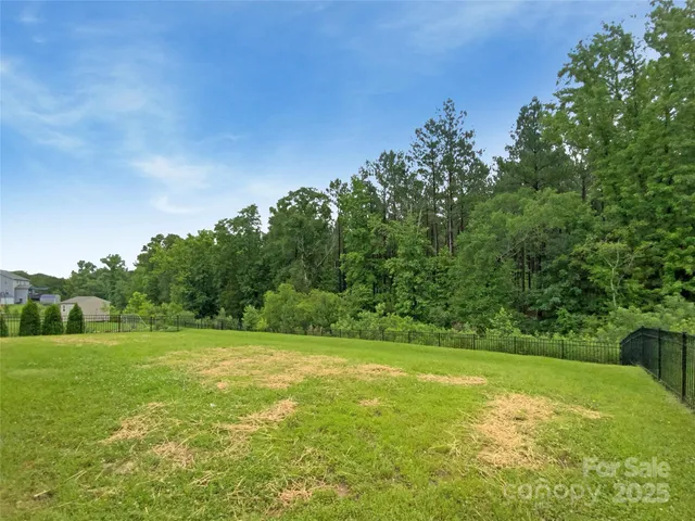 a large house with a big yard and large trees
