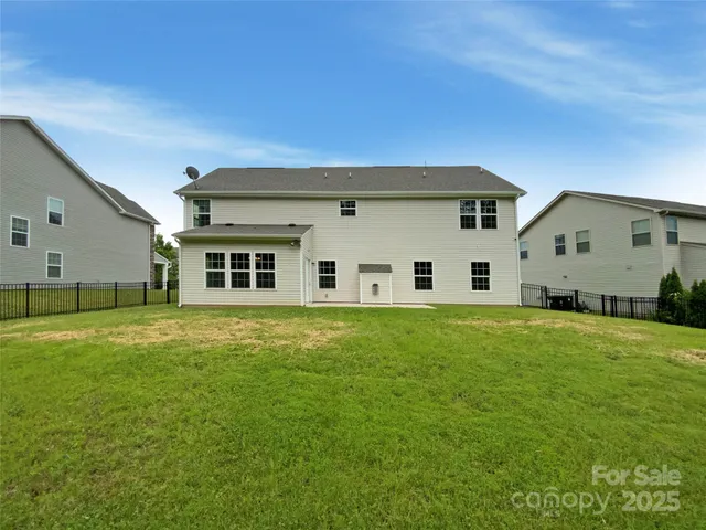 a big house with a big yard and large trees